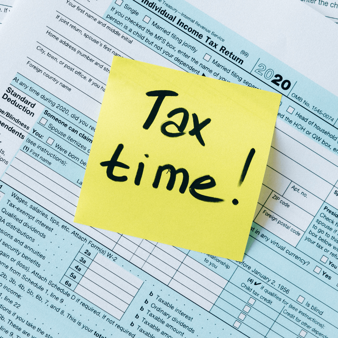 2020 tax forms with a yellow post-it note that has Tax Time written on it in black marker