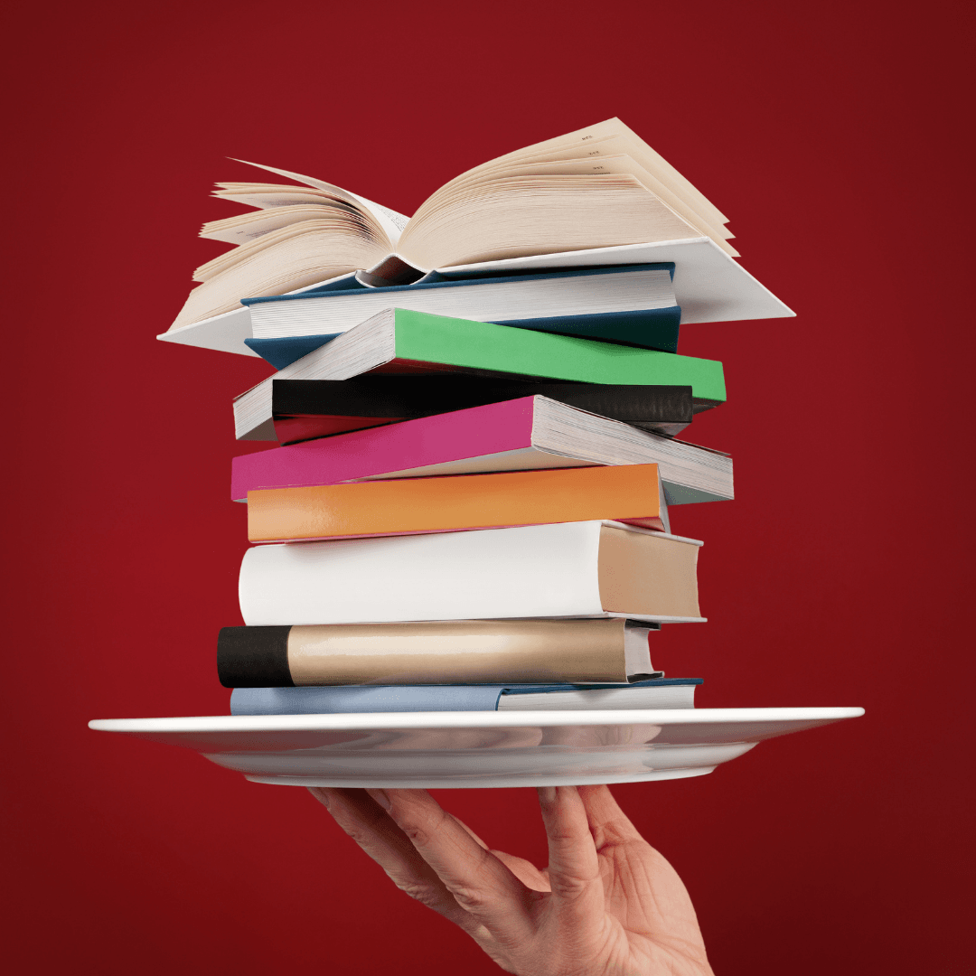 hand up plate with a stack of books on it, top book open