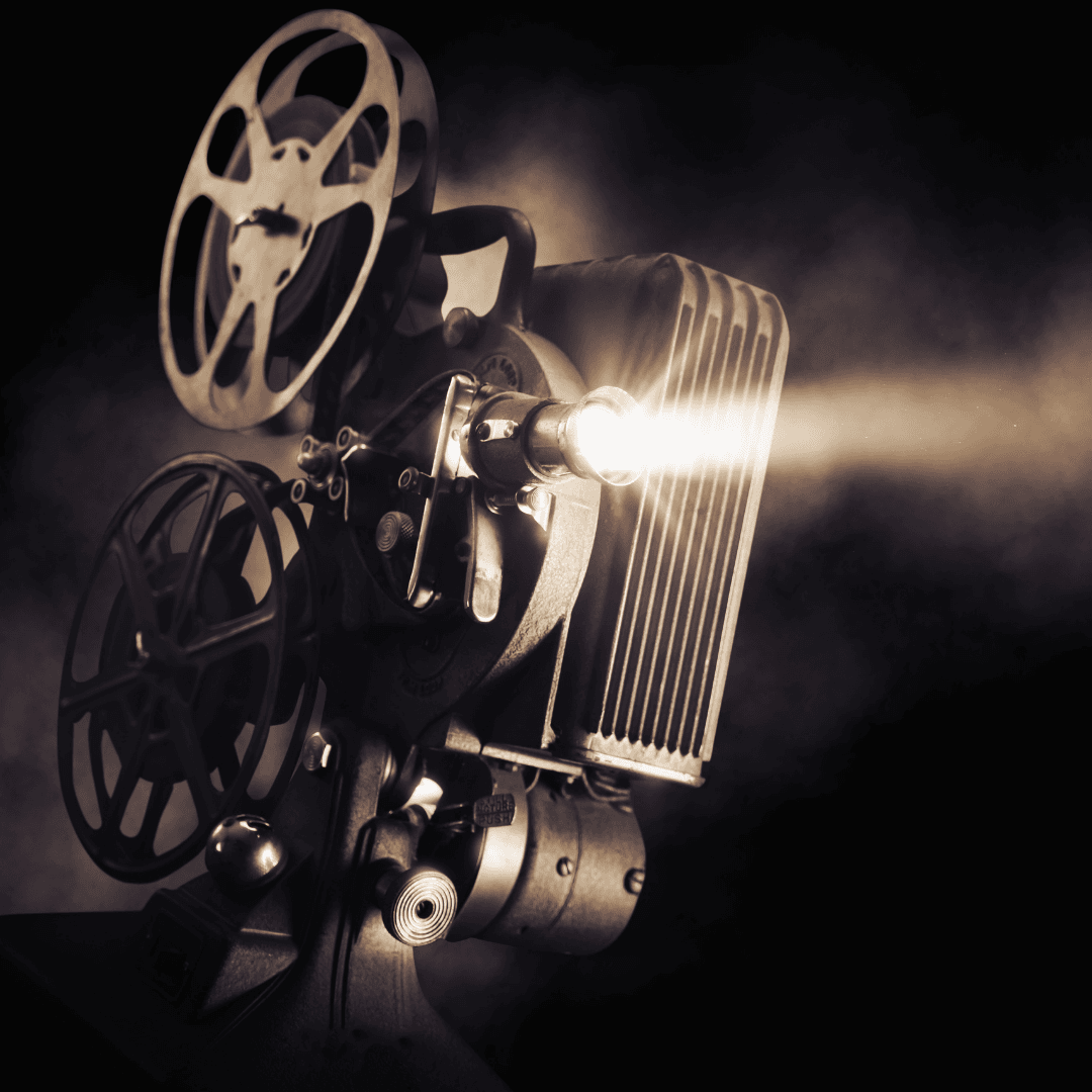 Antique file projector with light coming out of it as if playing a movie