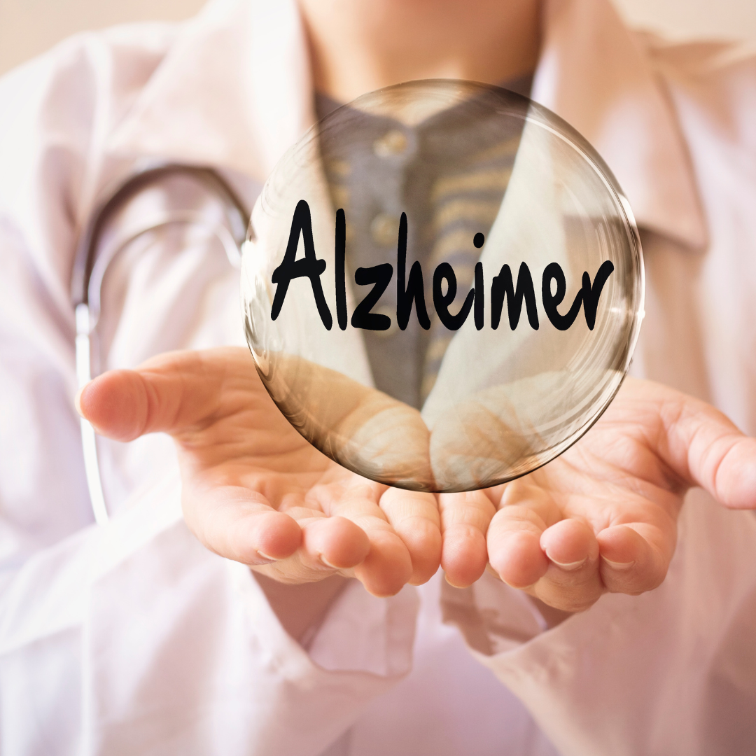 person in white medical type jacket holding a bubble with the word Alzheimer written on it