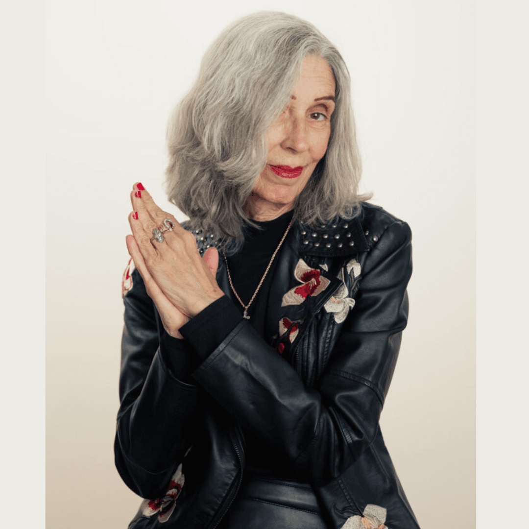 Photograph of Donna Frost in a black leather jacket with flowers on it. 