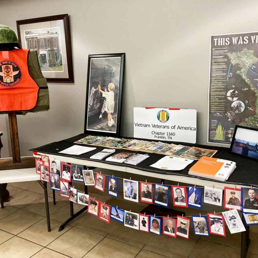 Photo of memorabilia on and near a table in the library vestibule / foyer