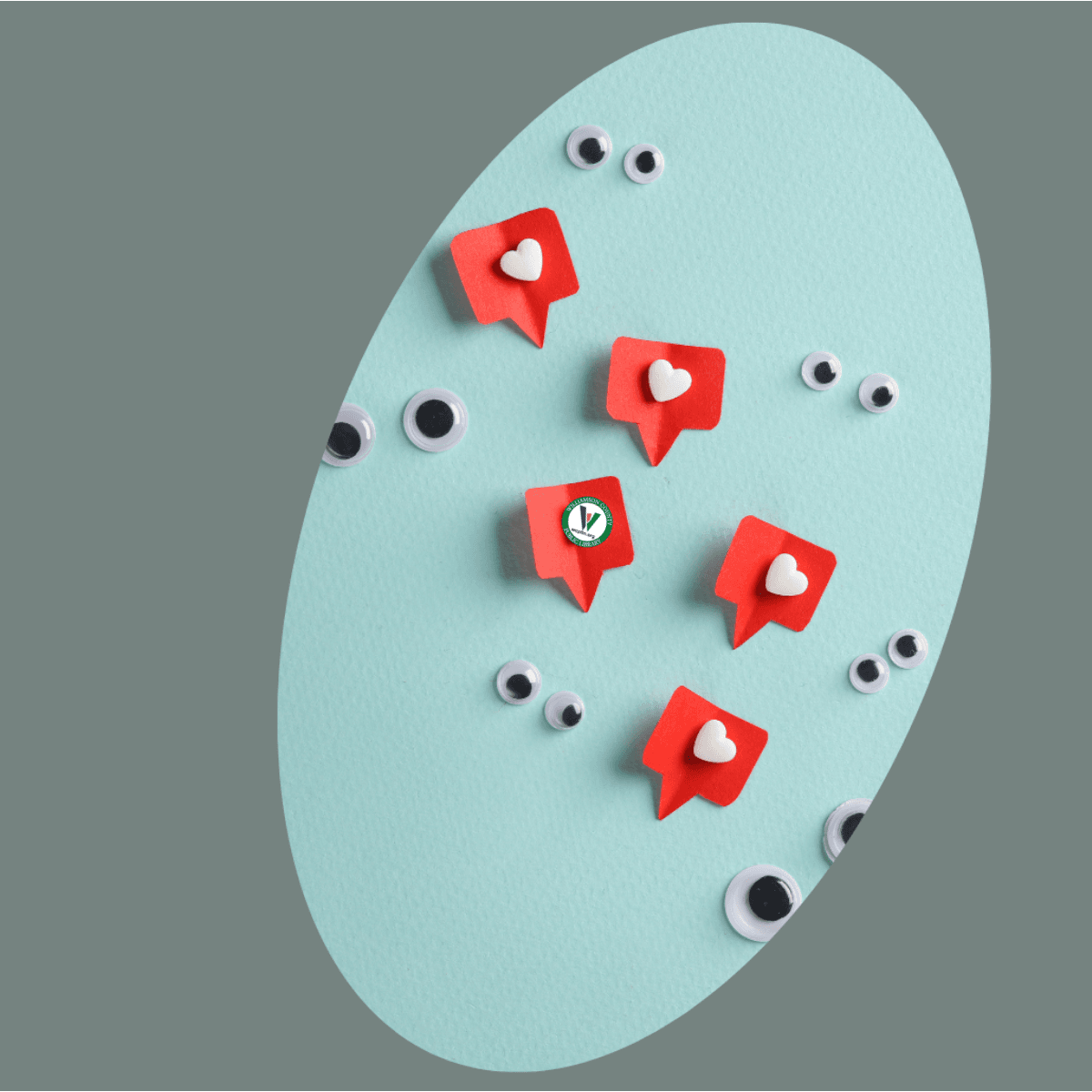 Oval with conversation cutouts in red with white hearts and adhesive black wiggly eyes in pairs