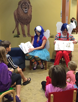 Mary and Katy read Smile Spotters to a group of children