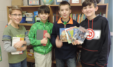 Group of boys holding books
