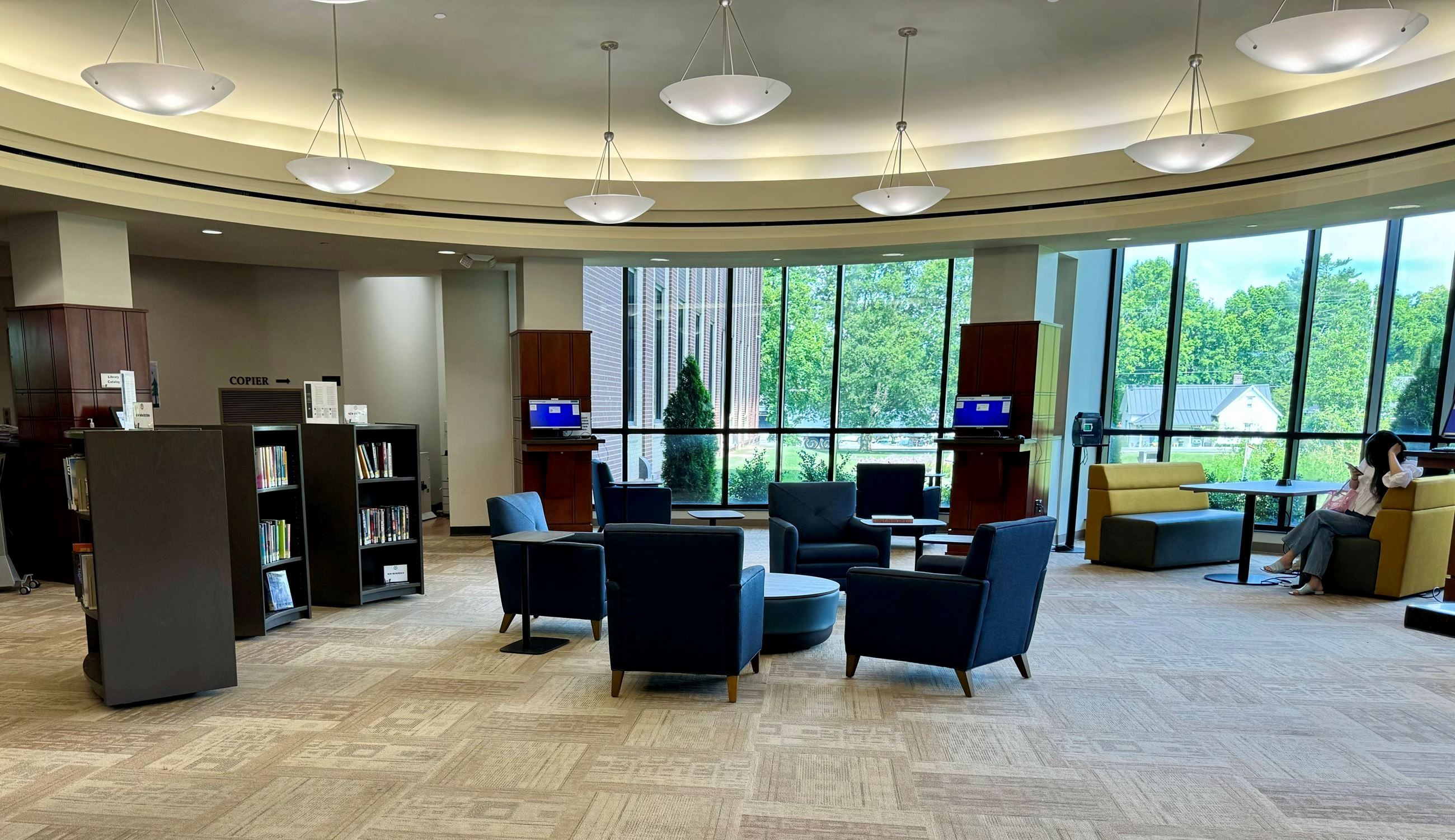 First floor rotunda new furniture, armchairs and tables, booth seating, curving shelves